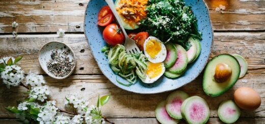 poached egg with vegetables and tomatoes on blue plate