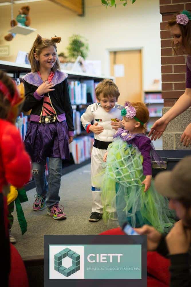 children in different costume standing inside room