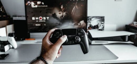 a person holding a video game controller in front of a tv